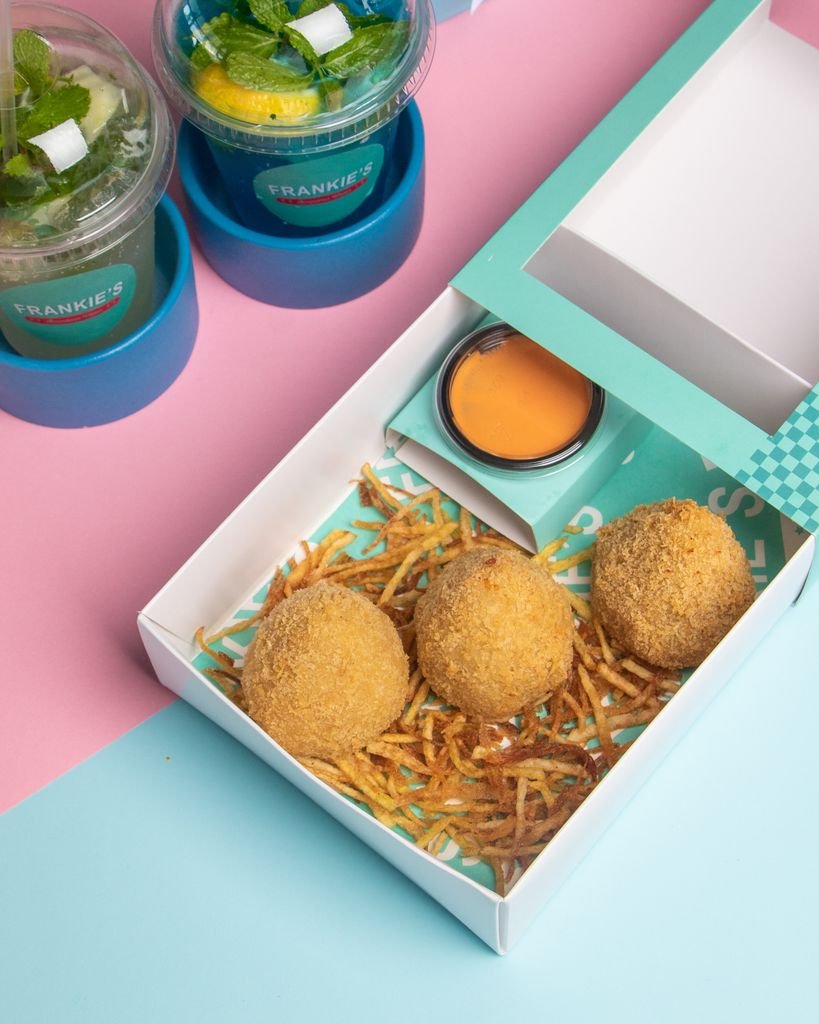 Delicious gourmet snacks served with refreshing drinks, perfect for a delightful meal.